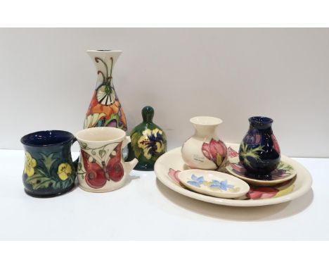 A collection of Moorcroft pottery including a MCC 2008 vase, a hibiscus bell, two mugs, a anemone vase and dish, a magnolia p