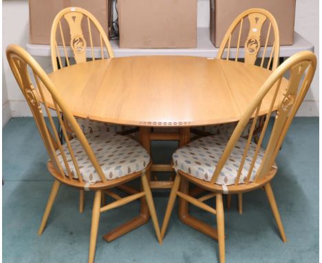 A 20th century blonde ash and beech Ercol drop end dining table, 72cm high x 124cm long x 113cm deep and four accompanying Er