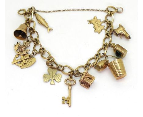A 9ct gold fancy chain charm bracelet, to include twelve 9ct and yellow metal charms, weight 25.2gms Condition Report:Availab