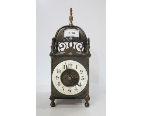 A Brass electric lantern clock with enamel ring dial Condition Report:Available upon request