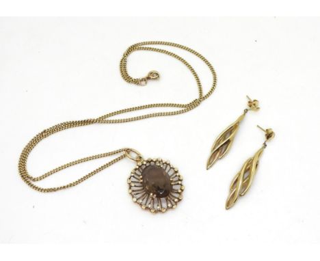 A 9ct gold retro smoky quartz pendant and 50cm chain, weight 9.8gms together with a pair of 14k gold earrings 1.2gms Conditio