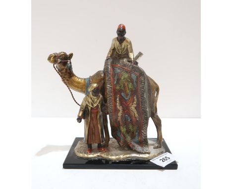 A cold painted table striker, modelled as two carpet sellers and a camel, in the style of Franz Bergman Condition Report:Avai