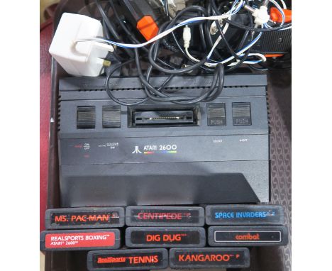 An Atari 2600 console, with a selection of games - Ms. Pac-Man, Boxing, Tennis, Dig Dug, Centipede, Space Invaders, Combat an