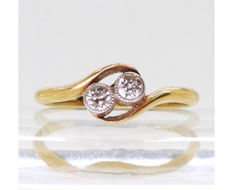 A bright yellow metal twin stone diamond ring, set with estimated approx 0.20cts of old cut diamonds, finger size M, weight 2