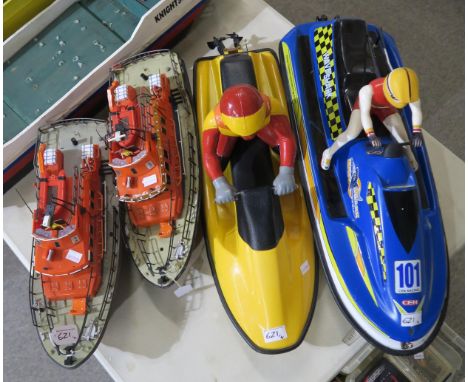 Two R/C RNLI pond lifeboats, each measuring approx. 47cm from prow to stern, together with two R/C jet-skiers, each approx. 6