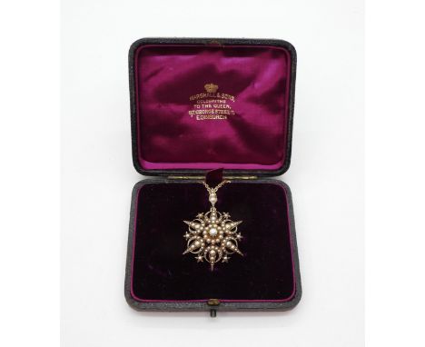 An Edwardian yellow metal pearl set 'Moon &amp; Stars' pendant with a 9ct gold chain. Length of pendant with bail 4.7cm, leng