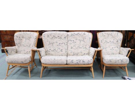 A 20th century elm and beech Ercol three piece suite comprising two seater rail back settee, 93cm high x 140cm wide x 84cm de