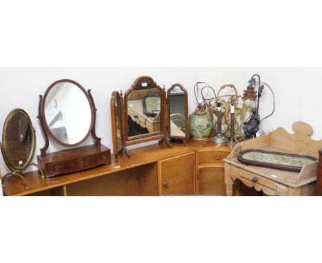 A lot comprising three assorted dressing mirrors, five assorted table lamps, a gilt magazine rack and a tapestry tray (10) Co