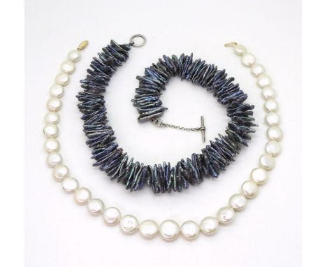 A baroque black fresh water pearl necklace each pearl is at least 2cm, with a silver toggle clasp length 48cm, together with 