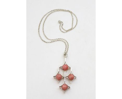 A stylised silver cross with tactile rhodochrosite spheres. made in Finland by Kultaseppa Salovaara Ky, with London import ma