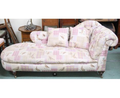 A button back upholstered chaise longue on turned supports terminating in brass casters, 80cm high x 176cm long x 78cm deep C