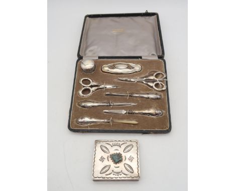 A cased silver stainless steel manicure set, by Samuel M Levi, Birmingham, and a Navajo white metal turquoise inlaid case (2)