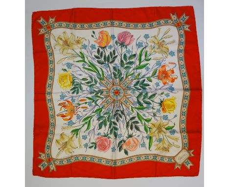 Hermès - a silk scarf the pink ribbon frame enclosing stirrups and other motifs the centre inscribed Etriers, Hermès, Paris, 