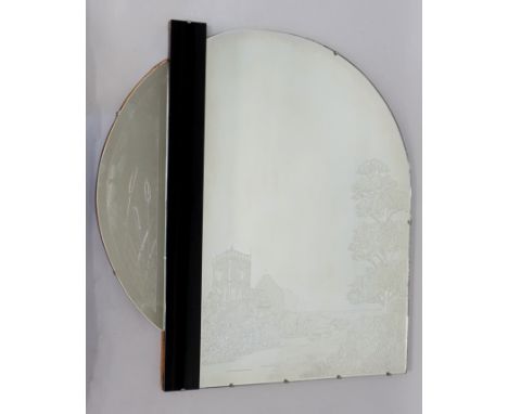 A decorative wall mirror in Art Deco style, the shaped plate acid etched with a landscape scene and church flanked by a verti
