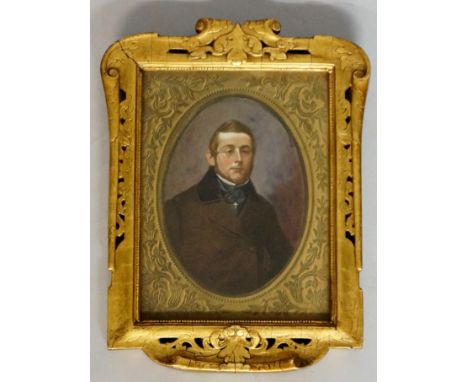 A pair of late 19th / early 20th Century oval portrait miniatures of a gentleman and his wife, the painted ovals within print
