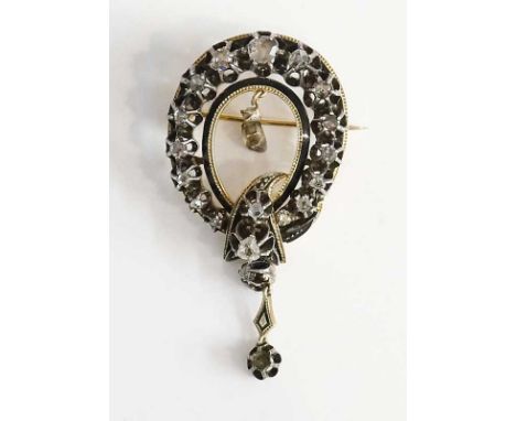 A Victorian 9ct gold and enamel horseshoe shaped brooch, claw set graduated old cut brilliants around a black enamel and mill