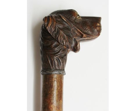 A 19th Century walking stick with articulated Black Forest carved dog's head terminal, moveable lower jaw, mismatched inset g