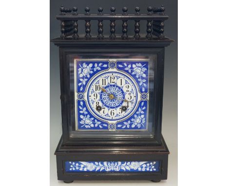 An ebonised Arts & Crafts mantel clock, the top with three quarter balustrade, the square dial enamelled with Arabic numeral 