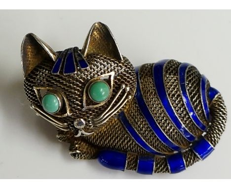 A silver and enamel mesh cat brooch, the recumbent feline with blue enamel bands and turquoise cabochon eyes, 4.5cm wide