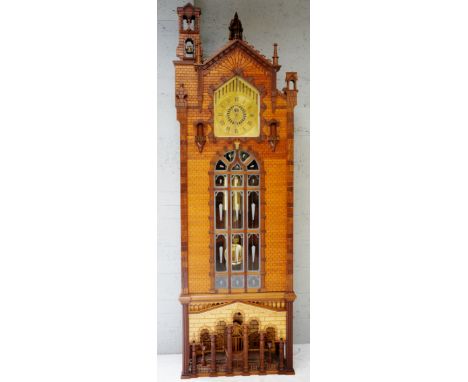 A longcase clock of architectural proportions, the brass dial pierced to the top with vertical bars with veneered wooden plaq