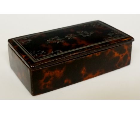 A George III faux tortoiseshell and steel snuff box of rectangular outline, the hinged lid with central floral arabesque in s