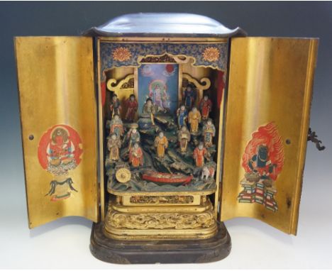 A 19th Century Chinese lacquered cabinet the shallow domed rounded rectangular top above a pair of doors applied bronzed foli