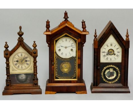 Three American mantel clocks all with paper dials and spring driven movements in ornate cases, spire finials, 45cm high and s