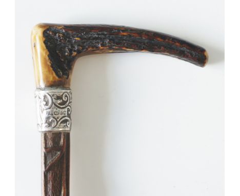 A 19th Century walking stick with stag horn handle, scrolling foliate chased and embossed collar, vacant shield cartouche, ma