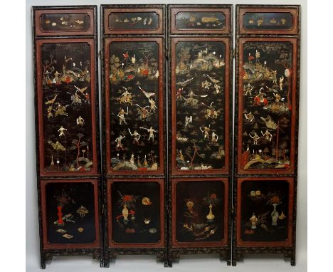 A 19th Century Chinese lacquer four fold screen, each leaf with large panel decorated with hardstones, mother of pearl and la