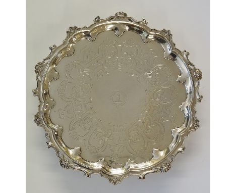 A silver salver with central armorial crest surround by motto 'Magnus hippocrates tu nobis maior', the body engraved with flo