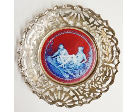 A silver and enamel dish, scrolling foliate pierced sides, shaped reeded rim, the centre with pink and blue enamel painting o