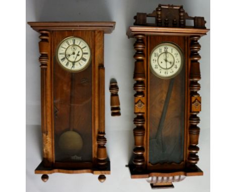 A Vienna wall clock with flared cornice, the walnut case with arched glazed door enclosing a cream enamel dial with subsidiar