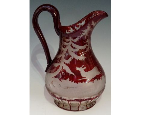 A good Bohemian ruby flashed jug, the body finely engraved with a stag and doe galloping through a forest setting, facet cut 