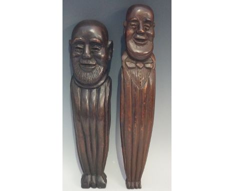 A 19th Century carved wooden head of a bearded bald headed smiling elderly gentleman, on a fluted tapered column, 37cm high; 