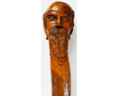 A 19th Century folk art oak walking stick, the terminal carved as an elderly gentleman with moustache and beard, broad shaft,