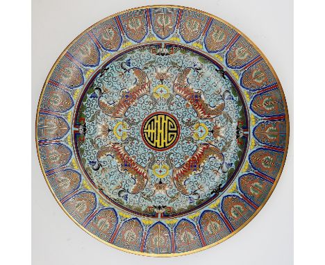 A Japanese cloisonné enamel circular dish, the centre decorated with four stylised bats surrounding a circular filled mon on 