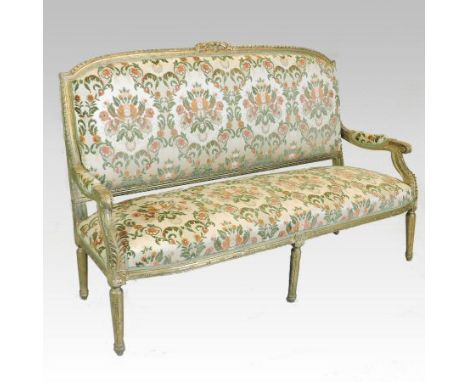 A Louis XVI style carved giltwood and floral upholstered sofa, on reeded legs, 164cm