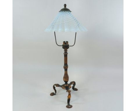 An Arts and Crafts brass table lamp, in the manner of W. A. S. Benson, having an opaque frilled glass shade, on a knopped ste