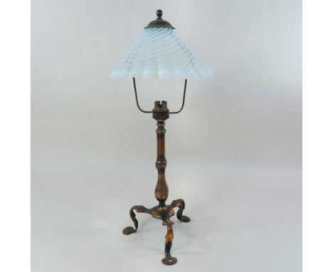 An Arts and Crafts brass table lamp, in the manner of W. A. S. Benson, having an opaque frilled glass shade, on a knopped ste