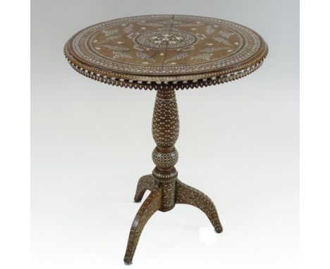 An early 20th century Moorish hardwood occasional table, finely inlaid throughout with bone and ebony scrolled foliate design