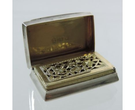 A George III silver vinaigrette, of hinged rectangular shape, with engine turned decoration, the gilt interior with a floral 