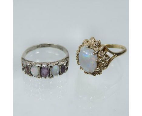 A 9 carat gold opal single stone ring, the oval cabochon stone within a textured surround, together with an opal and amethyst