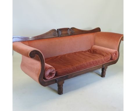 A Regency carved mahogany and red upholstered scroll end sofa, on turned legs, 205cm