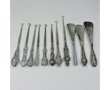 A collection of eleven various 19th century and later silver handled button hooks and shoe horns, various makers and dates (1