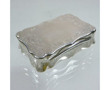A Victorian silver snuff box, of hinged rectangular shape, with scrolled decoration, makers mark CC, Birmingham 1887, 6.5cm w