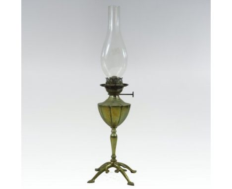 An Arts and Crafts brass oil lamp, in the style of W. A. S. Benson, having a lobed reservoir, on a tapered stem and four styl