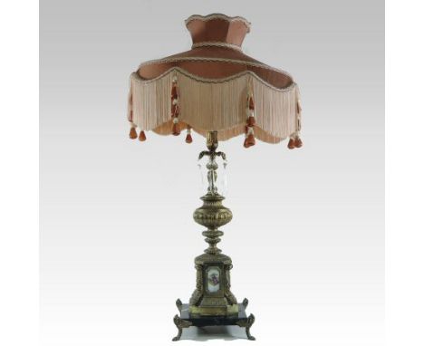 A continental gilt metal table lamp, with porcelain panels, suspended with glass lustres, on a marble base, with a fabric sha