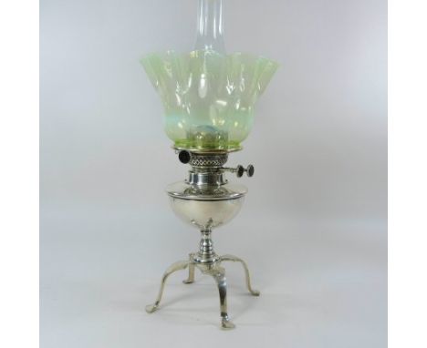 An Arts and Crafts silver plated oil lamp and shade, by Benson and Co., having a circular reservoir, on a turned stem and fou