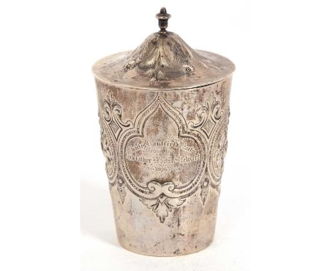 A Victorian silver caddy of tapering cylindrical form, elaborately embossed, chased and engraved with flowers, scrolls, leave