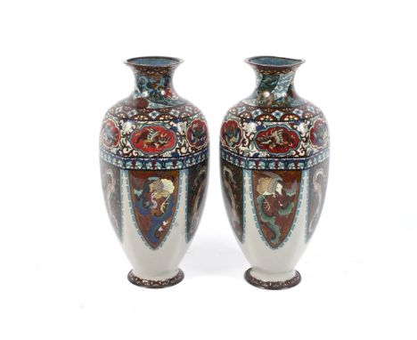 A pair of Japanese Meiji period cloisonne vases. Each of tapering panelled form, decorated with flaming dragons on glitter gr